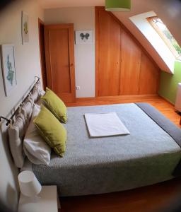 a bedroom with a large bed with a skylight at Cozy & Quiet Apartment. in Sada