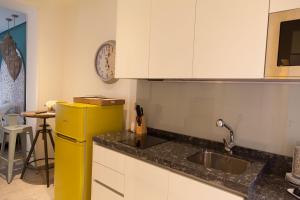 a kitchen with a yellow refrigerator and a sink at Apartamento City SOLO ADULTOS in Madrid