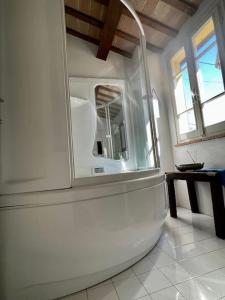 a white refrigerator in a room with a table at la casina nel tempo in Santarcangelo di Romagna