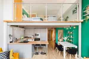 a loft apartment with green walls and a kitchen and dining room at The Exquisite Duplex of Central Nottingham in Nottingham