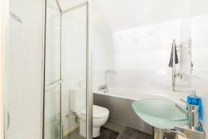 a bathroom with a toilet and a sink and a shower at The Exquisite Duplex of Central Nottingham in Nottingham