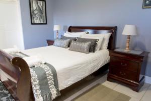 - une chambre avec un lit doté d'une tête de lit en bois et d'oreillers dans l'établissement Apollis Cottage, à Springbok