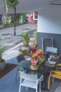 a table with flowers and chairs on a patio at Ilet du Lagon in La Saline les Bains