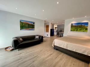 ein Schlafzimmer mit einem Bett und einem Sofa in der Unterkunft "Mittendrin" in Garmisch in Garmisch-Partenkirchen