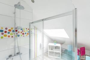 a shower with a glass door in a bathroom at Ô Gris Cottage in Durbuy
