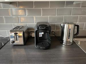 a kitchen counter with a coffee maker and a toaster at Harvey Apartments in Derry Londonderry