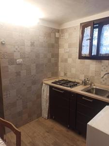 a kitchen with a sink and a stove at Al Vicoletto in Taranto