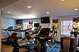 a gym with several cardio machines in a room at Penn Harris Hotel Harrisburg, Trademark by Wyndham in Harrisburg