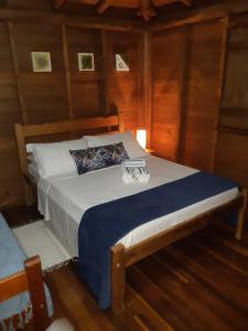 a bedroom with a bed with two glasses on it at Pousada Recanto Afetivo in Trindade