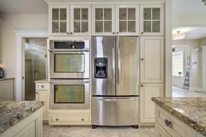 a kitchen with a stainless steel refrigerator and cabinets at Ventnor City Retreat about 1 Block To Boardwalk! in Ventnor City
