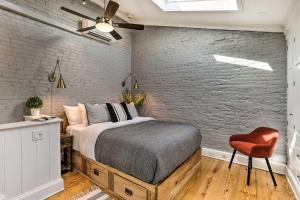 a bedroom with a bed and a brick wall at Historic Home with Garden Walk to Center City! in Philadelphia