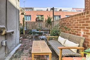 a patio with a bench and a table and a brick wall at Historic Home with Garden Walk to Center City! in Philadelphia