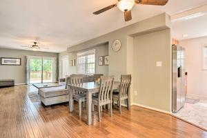a dining room and living room with a table and chairs at Sunny Glen Burnie Home - On-Site Water Access in Glen Burnie