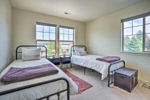 two beds in a room with two windows at Serene Bend Getaway with Hot Tub and Fire Pit! in Bend