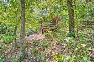 a log cabin in the woods with trees at Bright Davis Escape with Screened-In Porch! in Davis
