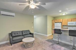 a living room with a couch and a ceiling fan at Cozy Cleveland Apartment about 2 Mi to Downtown! in Cleveland
