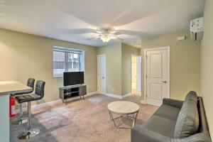 a living room with a couch and a television at Cozy Cleveland Apartment about 2 Mi to Downtown! in Cleveland