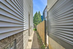 an alley between two buildings with a fence at Cozy Cleveland Apartment about 2 Mi to Downtown! in Cleveland
