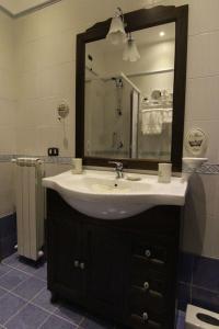 a bathroom with a sink and a mirror at Villa Delle Camelie in Gragnano