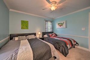 a bedroom with two beds and a ceiling fan at Peaceful Country Retreat with Easy Highway Access! in Monticello +27 photos