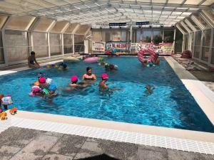 een groep mensen in een zwembad bij Alloggio con piscina a Sorso 3 kilometri dal mare in Sorso