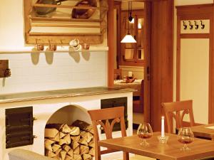 a living room with a table and a fireplace at GRÜNER Alpengasthof inkl Summercard in Sölden