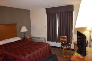 a hotel room with a bed and a window at MHO Hotel Bordentown in Bordentown