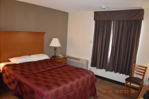 a hotel room with a bed and a window at MHO Hotel Bordentown in Bordentown