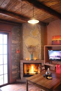 a living room with a fireplace and a television at jade in Ubrique