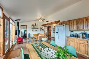 a kitchen and dining room with a table and a refrigerator at El Prado Duplex with Deck and Grill - 4 Mi to Town! in El Prado