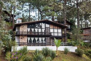 a house in the woods with a balcony at Monteverde in Mazamitla