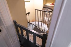 a stairway with two wooden chairs in a hallway at Stylish Central 2 Bedroom Apartment in Hereford +25 photos