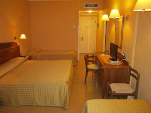 Postel nebo postele na pokoji v ubytování Hotel Conchiglia d'Oro