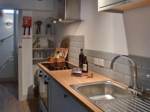 a kitchen with a sink and a counter top at Ty Bobbet in Amlwch