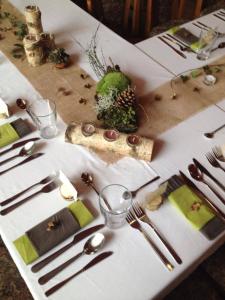 a table with a white table cloth with forks and knives at Hotel Zlaty Jelen in Horažďovice