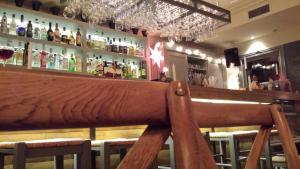 a bar with many bottles of alcohol on the wall at Xanthippi Hotel in Souvala
