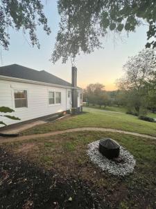a yard with a house and a black object in the grass at Cozy and Renovated 3 Bedroom Home 