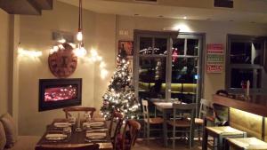 a room with a christmas tree in a restaurant at Xanthippi Hotel in Souvala
