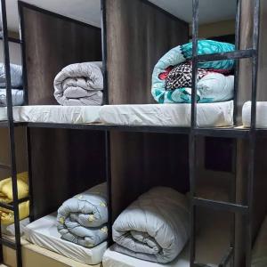 a group of bunk beds with towels on them at Flintstones Backpackers in Lusaka