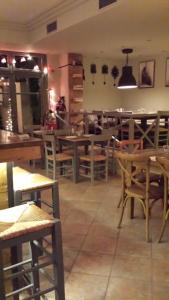 a dining room with wooden tables and chairs at Xanthippi Hotel in Souvala