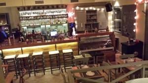 a bar with a lot of chairs and a counter at Xanthippi Hotel in Souvala
