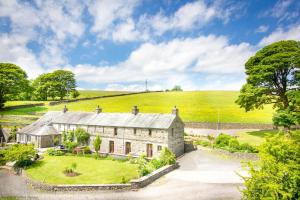 an old stone house in the middle of a field at Coomb View at Sandbeds in Kendal