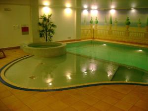 a pool with a fountain in the middle of a building at Coomb View at Sandbeds in Kendal