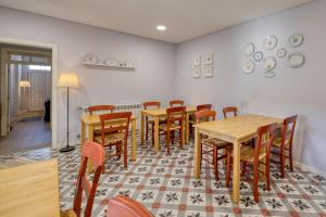 une salle à manger avec des tables et des chaises en bois dans l'établissement Casa Da Lagoa e Forja - Turismo Rural, à Mira