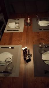a wooden table with plates and candles on top of it at Xanthippi Hotel in Souvala