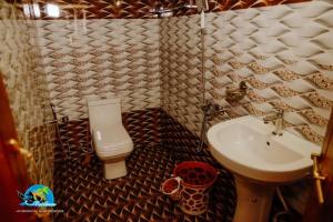 a small bathroom with a sink and a toilet at Vaishnav Tours in Alleppey