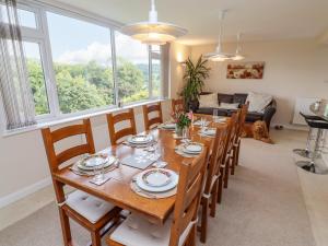 a dining room with a table and chairs and a dog at The Gables in Stroud