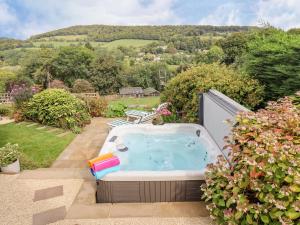 a hot tub in the backyard of a garden at The Gables in Stroud