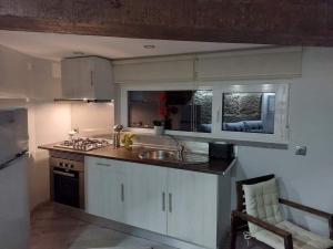 a kitchen with a sink and a stove at Casas Zé Pinto in Hospital