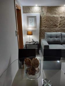 a living room with a glass table and a couch at Casas Zé Pinto in Hospital